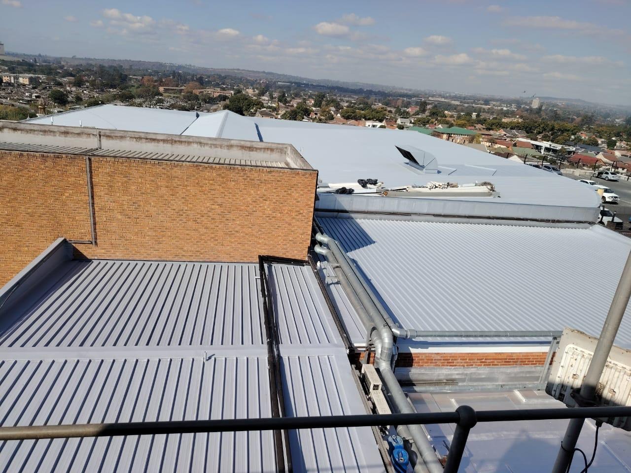 ERI crew coating a vast industrial roof at height